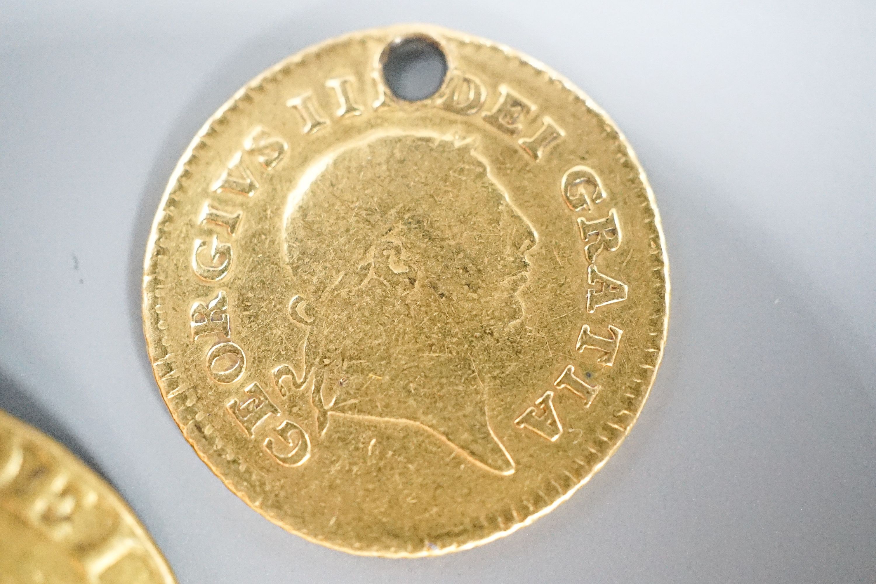 A George III 1788 gold guinea, now with pendant loop and an 1804 gold one third guinea(hole).